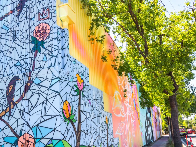 A colourful mural on the side of a building on the corner of Queen Street and Port Road